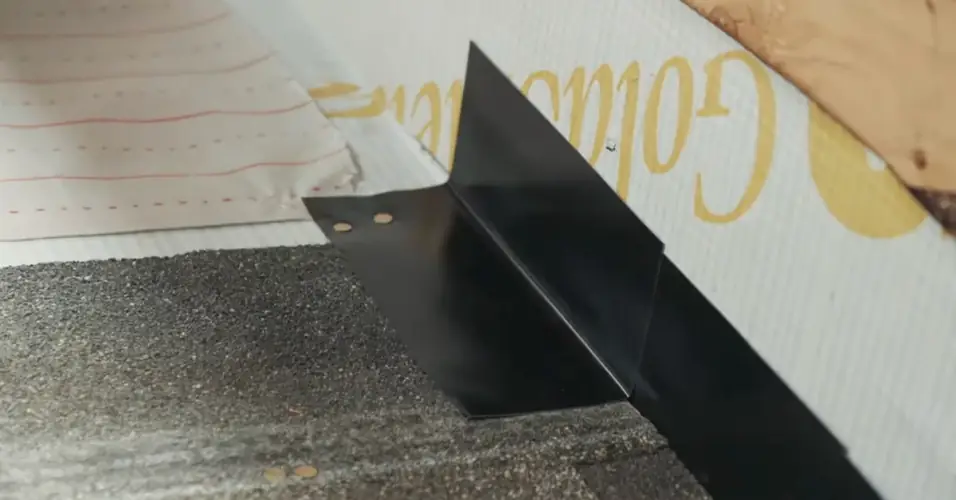 IKO installation example: metal step flashing at a shingle roof-to-wall junction IKO installation example: metal step flashing at a shingle roof-to-wall junction